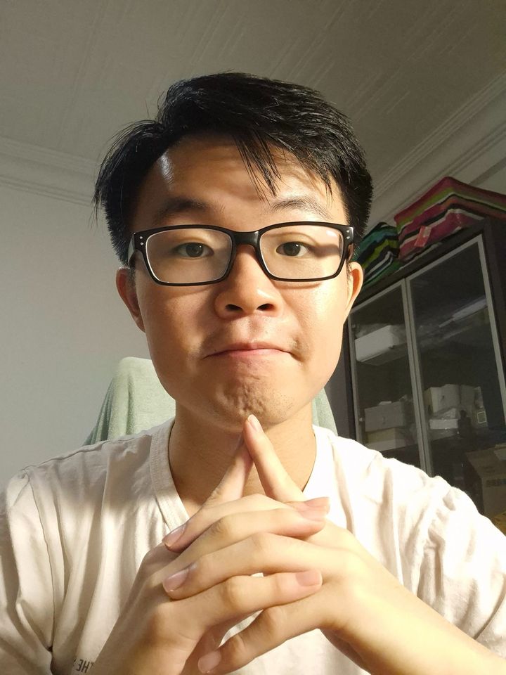 Chuan Long with his hands folded, thinking