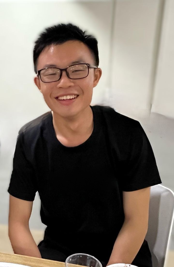 Chuan Long smiling, in a black T-shirt